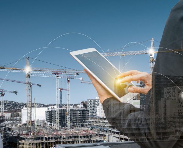 double-exposure-businesswoman-touching-tablet-with-network-line-construction-building-background-min